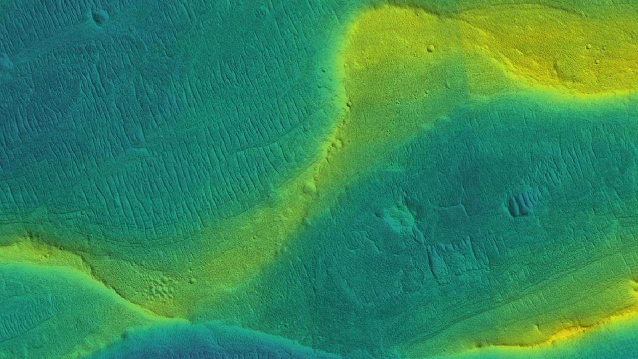 A photo of a preserved river channel on Mars, taken by an orbiting satellite, with color overlaid to show different elevations (blue is low, yellow is high).