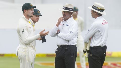 Steve Smith and Cameron Bancroft are confronted by umpires Richard Illingworth and Nigel Llong during the Test match in South Africa that saw the scandal emerge.