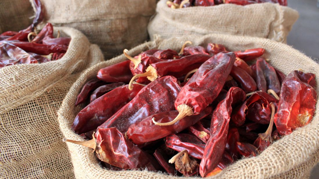 <strong>Red, green, or Christmas?</strong> That's New Mexico parlance for "How do you prefer your chile?" Here, sacks of dried red chile pods are displayed in Hatch, New Mexico, the self-proclaimed "Chile Capital of the World."