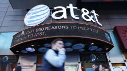 People walk past an AT&T store in New York on October 23, 2016. 
AT&T unveiled a mega-deal for Time Warner that would transform the telecom giant into a media-entertainment powerhouse positioned for a sector facing major technology changes. The stock-and-cash deal is valued at $108.7 billion including debt, and gives a value of $84.5 billion to Time Warner -- a major name in the sector that includes the Warner Bros. studios in Hollywood and an array of TV assets such as HBO and CNN. / AFP / KENA BETANCUR        (Photo credit should read KENA BETANCUR/AFP/Getty Images)