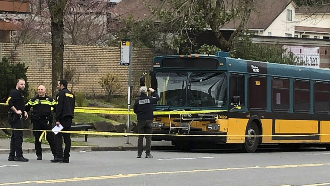 Investigators work on the scene of a shooting in Seattle on Wednesday, March 27, 2019. Authorities say four people, including a Metro bus driver, were shot and one person has been detained. (AP Photo/Gene Johnson)
