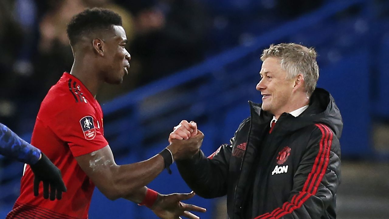 Manchester United manager Ole Gunnar Solskjaer (right) with midfielder Paul Pogba.