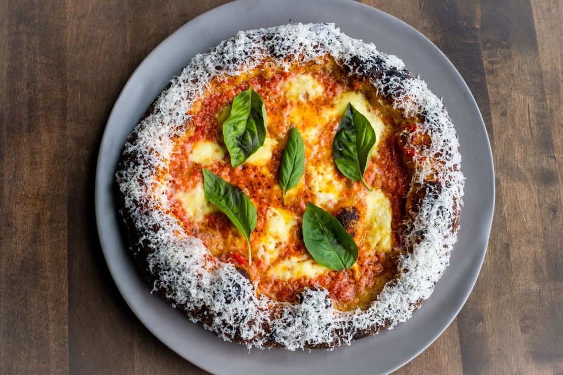 Che Fico's margherita pizza is finished with fresh basil, sweet as can be.