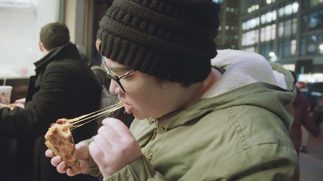 Becca Joyner samples a slice of NYC pizza.