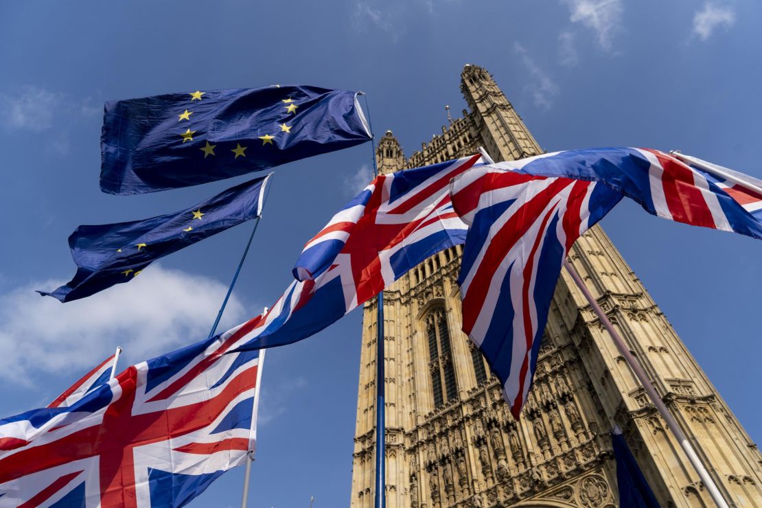 Union and EU fags flutter outside the Houses of Parliament in Westminster, London on March 28, 2019. 