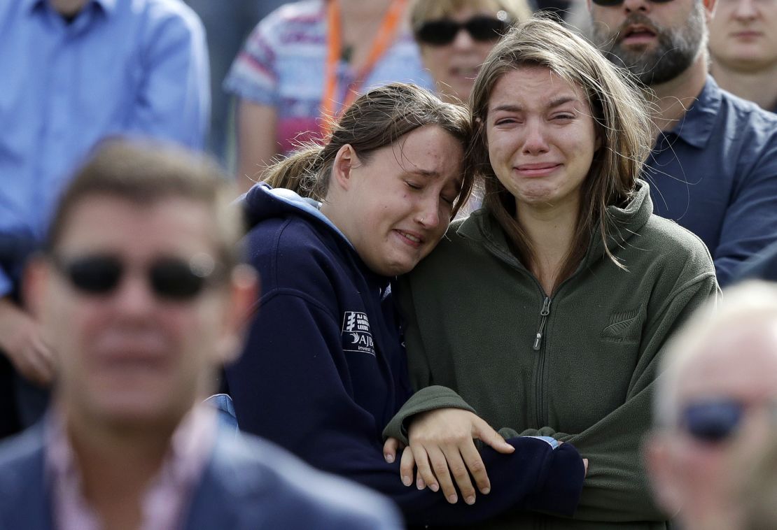 Women react as the New Zealand national anthem is sung during a national remembrance service in Hagley Park for the victims of the March 15 mosque terrorist attack in Christchurch, New Zealand.