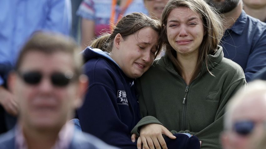 Women react as the New Zealand national anthem is sung during a national remembrance service in Hagley Park for the victims of the March 15 mosque terrorist attack in Christchurch, New Zealand, Friday, March 29, 2019. (AP Photo/Mark Baker)