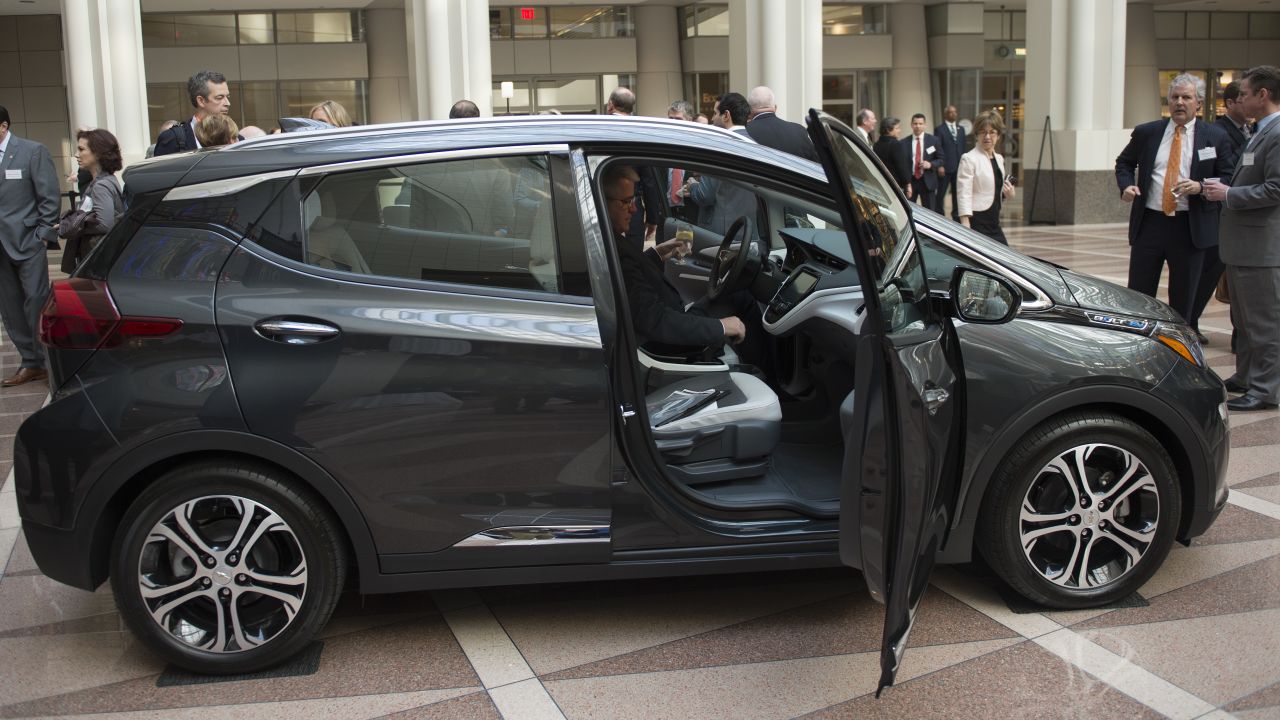 A man looks at a Chevrolet Bolt before attending a winter luncheon with Mary T. Barra, Chairman and CEO of General Motors Company in Washington, DC on February  28, 2017. / AFP / Andrew CABALLERO-REYNOLDS        (Photo credit should read ANDREW CABALLERO-REYNOLDS/AFP/Getty Images)