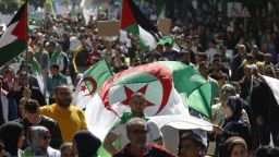 Demonstrators march with national flags during a protest in Algiers, Algeria, March 29, 2019. Algerians taking to the streets for their sixth straight Friday of protests aren't just angry at their ailing president, they want to bring down the entire political system that has sustained him. (AP Photo/Toufik Doudou)