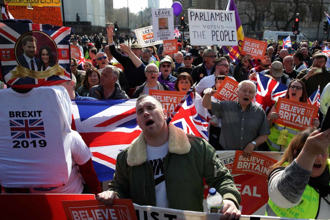 Pro-Brexit demonstrators carry placards and Union flags as they gather in Parliament Square in central London on March 29, 2019. 