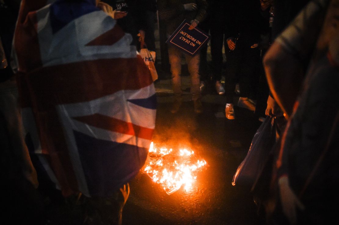 Pro-Brexit protesters burn an EU flag on Friday night in London.