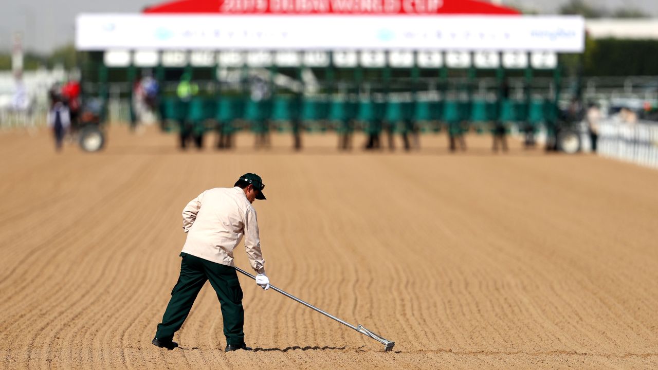 A groundsman prepares the course before a race during the Dubai World Cup at Meydan Racecourse on March 30 in Dubai.