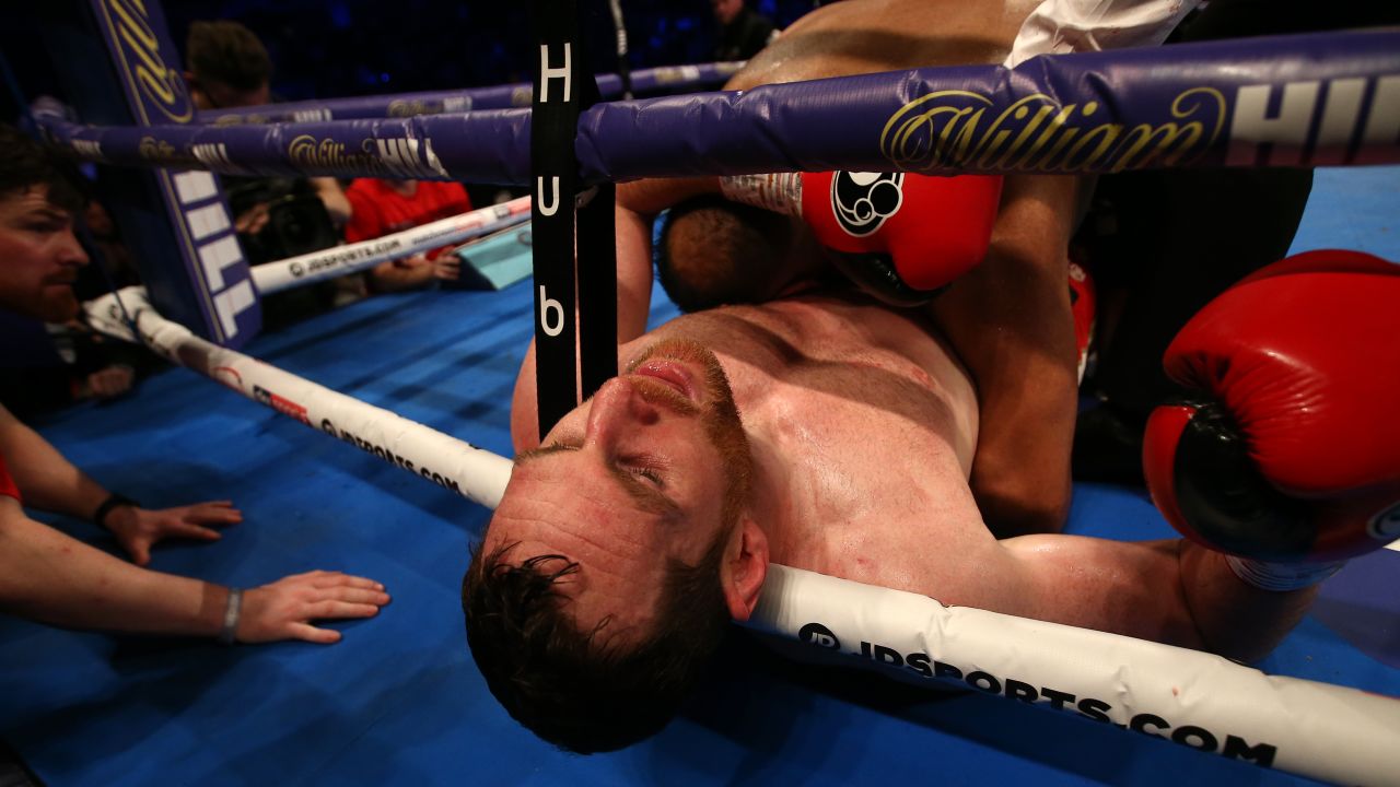 Price reacts after being bitten by in Kash Ali during their heavyweight bout.
