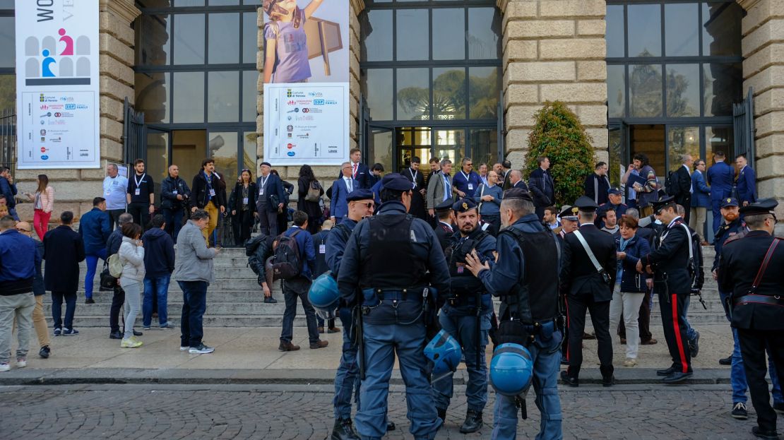 Riot police stand alert outside the World Congress of Families venue in the ancient city's Piazza Bra as a neo-fascist leader delivered a press conference outside.