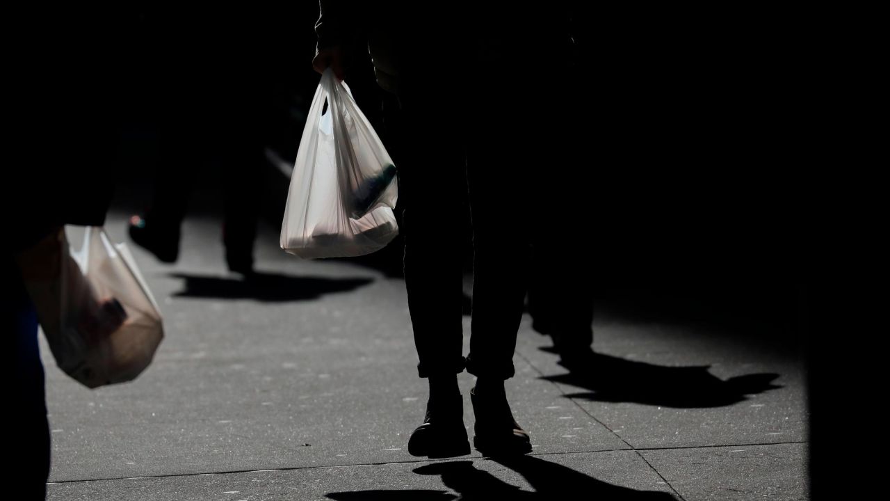  A New Yorker carries a plastic bag during lunch hour on January 15 in New York City.