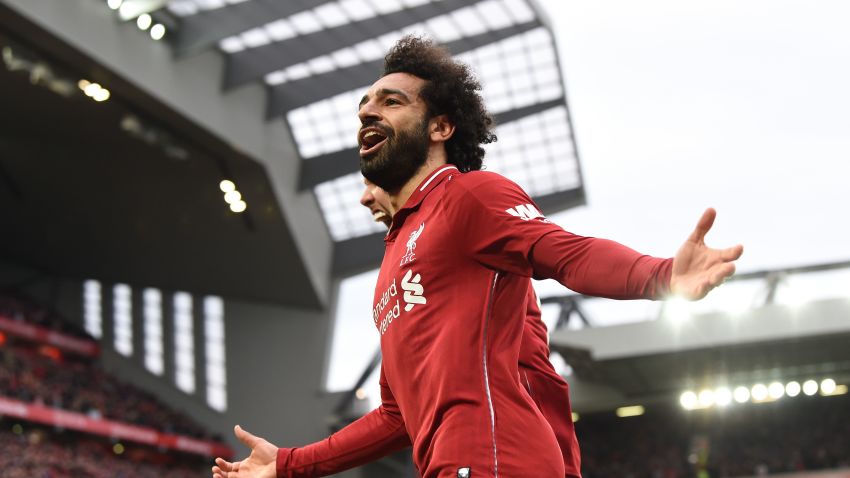 Liverpool's Egyptian midfielder Mohamed Salah celebrates after a late own goal from Tottenham Hotspur's Belgian defender Toby Alderweireld (not pictured) during the English Premier League football match between Liverpool and Tottenham Hotspur at Anfield in Liverpool, north west England on January 31, 2019. (Photo by Paul ELLIS / AFP) / RESTRICTED TO EDITORIAL USE. No use with unauthorized audio, video, data, fixture lists, club/league logos or 'live' services. Online in-match use limited to 120 images. An additional 40 images may be used in extra time. No video emulation. Social media in-match use limited to 120 images. An additional 40 images may be used in extra time. No use in betting publications, games or single club/league/player publications. /         (Photo credit should read PAUL ELLIS/AFP/Getty Images)