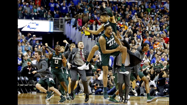Michigan State Spartans teammates Nick Ward (44) and Kenny Goins (25) celebrate after <a href="index.php?page=&url=https%3A%2F%2Fbleacherreport.com%2Farticles%2F2828858-cassius-winston-michigan-st-stun-zion-williamson-duke-to-advance-to-final-four" target="_blank" target="_blank">beating the No.1 overall seed</a> Duke Blue Devils in their Elite Eight matchup of the 2019 NCAA Tournament at Capital One Arena on Sunday, March 31. The Spartans' win advances them to the Final Four for the 10th time in program history.