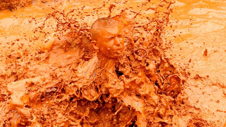 A competitor jumps into a mud pool during the "Run Mud" race in Tel Aviv, Israeli, on March 29.