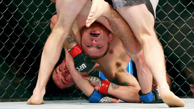 Ray Borg grapples with Casey Kenney during UFC Fight Night at Wells Fargo Center in Philadelphia on Saturday, March 30. Kenney won the fight by decision.