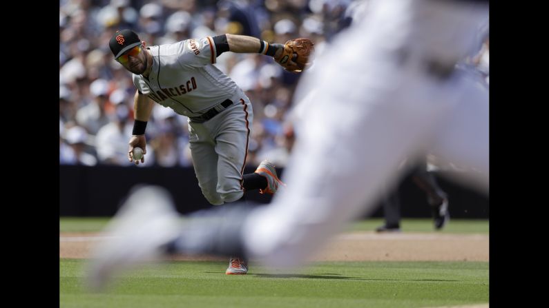 San Francisco Giants third baseman Evan Longoria fields a ball hit by Fernando Tatis Jr. of the San Diego Padres during the fourth inning of a baseball game in San Diego on Thursday, March 28.