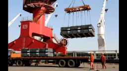 LIANYUNGANG, CHINA - MARCH 31: Cranes load containers onto a vehicle for shipment at a logistics base on March 31, 2019.
