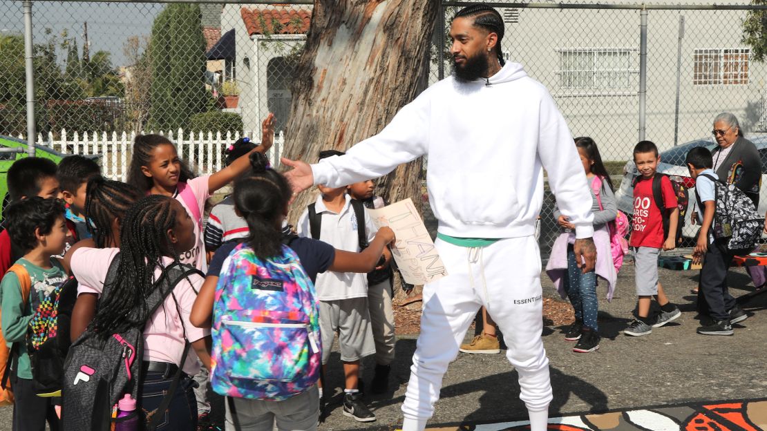 Nipsey Hussle greets kids during a community event in Los Angeles in October.