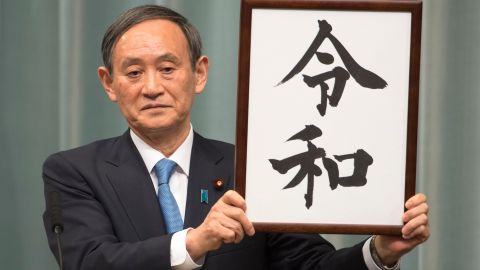 Japan's Chief Cabinet Secretary Yoshihide Suga announces the new era name, "Reiwa," during a press conference in Tokyo.