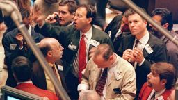 Traders crowd around a station on the floor of the New York Stock Exchange.