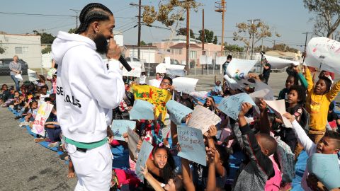Nipsey Hussle speaks to kids at a basketball court "refurbishment reveal" in Los Angeles in October. 