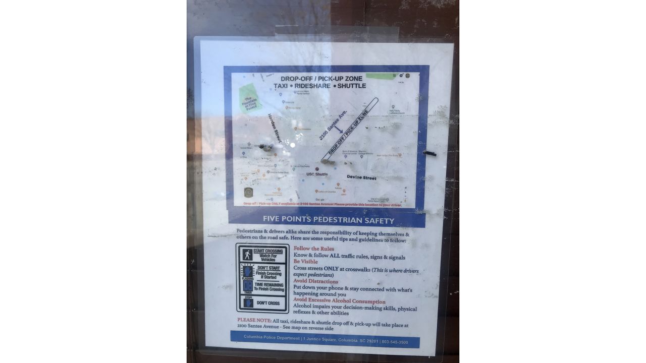 Ride-sharing guidelines and tips are plastered near businesses in downtown Columbia. 
