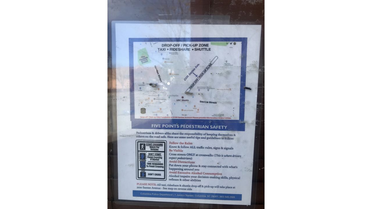 Ride-sharing guidelines and tips are plastered near businesses in downtown Columbia.