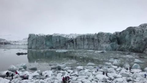 Tourists scramble after a glacier breaks in Iceland.