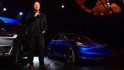 Tesla CEO Elon Musk speaks beside the just unveiled new Tesla Model Y (R) in Hawthorne, California on March 14, 2019. (Photo by Frederic J. BROWN / AFP)        (Photo credit should read FREDERIC J. BROWN/AFP/Getty Images)