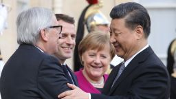 French President Emmanuel Macron (2ndL) welcomes EU Commission President Jean-Claude Juncker (L),  German Chancellor Angela Merkel (C) and Chinese President Xi Jinping (R) before a meeting at the Elysee Palace in Paris on March 26, 2019. - The leaders of China, France, Germany and the EU were set to meet in Paris on March 26 for "unprecedented" talks on how to improve ties, despite growing jitters over Beijing's massive investments in Europe. (Photo by ludovic MARIN / AFP)        (Photo credit should read LUDOVIC MARIN/AFP/Getty Images)