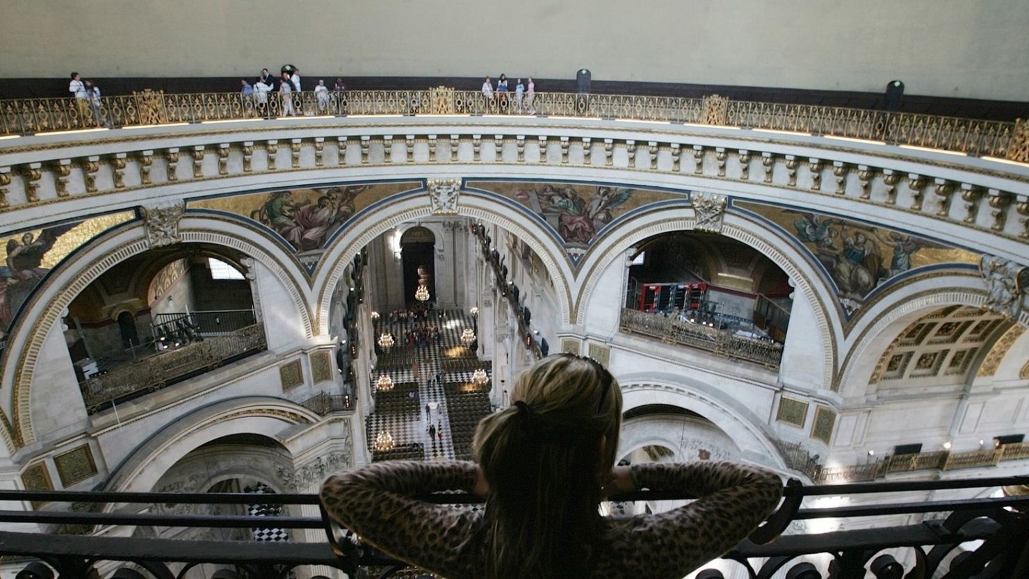 An unidentified visitor looks out from the Whispering Gallery of St. Paul's Cathedral in London.