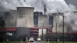 A picture taken on January 16, 2019 shows cars driving in front of smoke and vapor rising from the cooling towers and chimneys of the lignite-fired power plant Niederaussem run by German energy supplier RWE near Bergheim, western Germany. (Photo by Federico Gambarini / dpa / AFP) / Germany OUT        (Photo credit should read FEDERICO GAMBARINI/AFP/Getty Images)