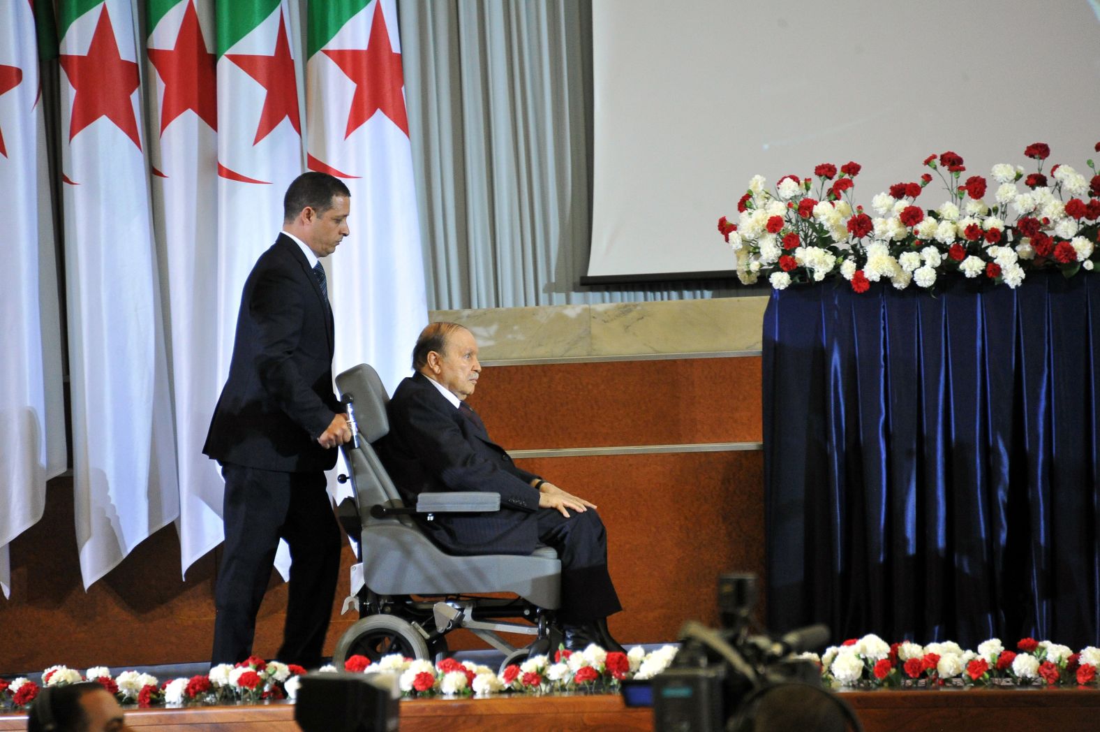 Bouteflika is wheeled across a stage during his swearing-in ceremony in April 2014. Bouteflika has rarely been seen in public since suffering a stroke in 2013.