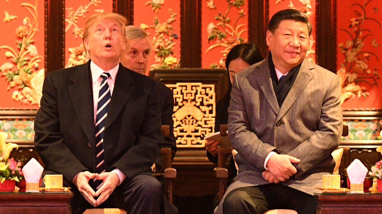 US President Donald Trump  looks up as he sits beside China's President Xi Jinping during a tour of the Forbidden City in Beijing on November 8, 2017. 