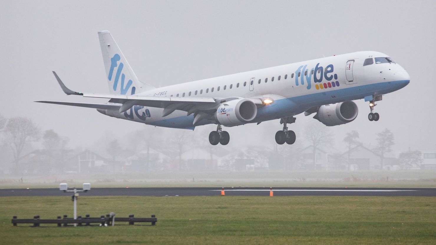 A Flybe Embraer aircraft lands at Amsterdam Schiphol International Airport.