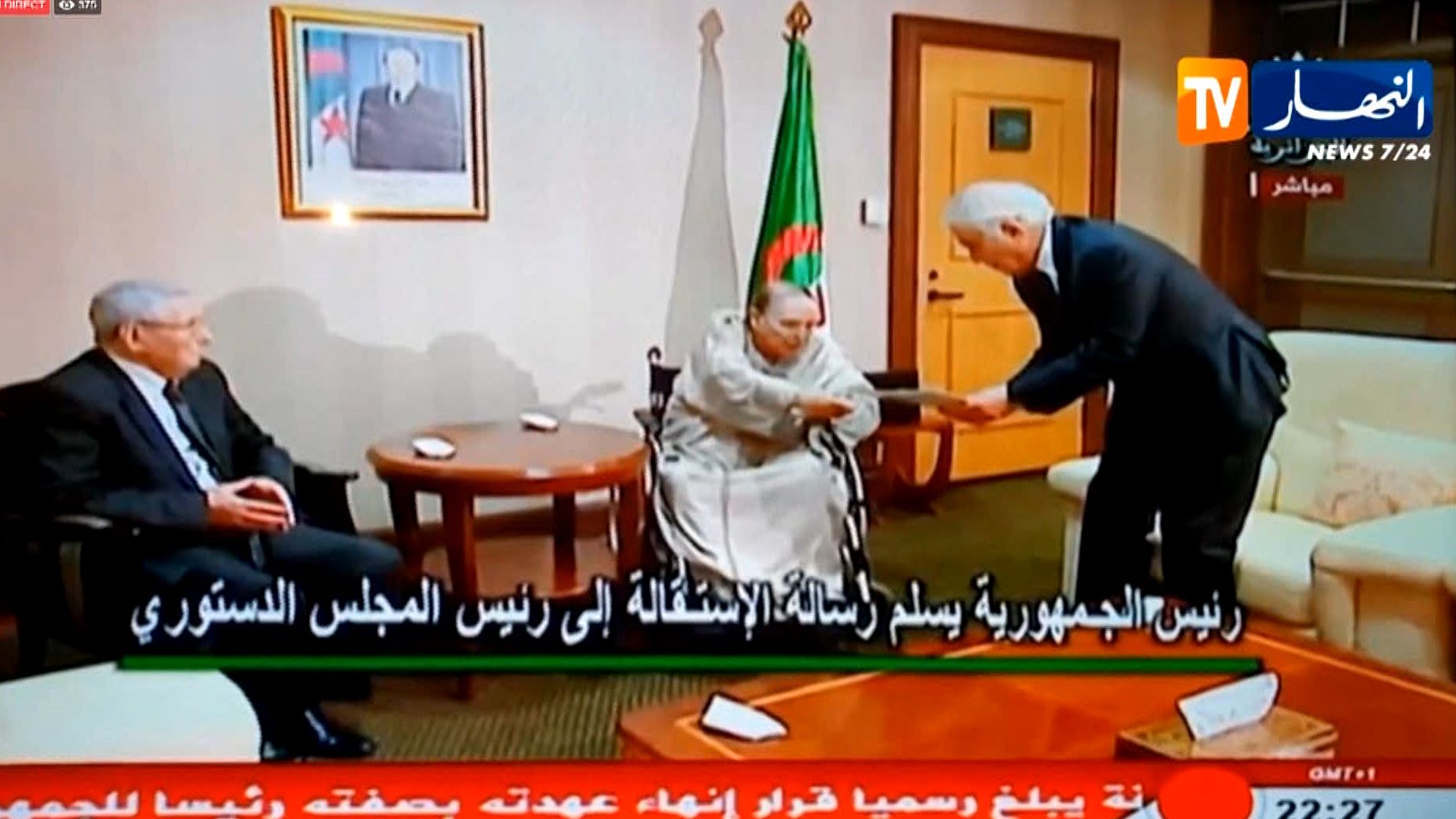 A TV grab from Ennahar TV shows Abdelaziz Bouteflika, center, hand in his resignation letter to the Constitutional Council in Algiers.