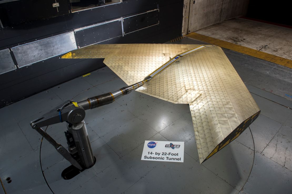 The wing's assembly is seen under construction, assembled from hundreds of identical subunits.