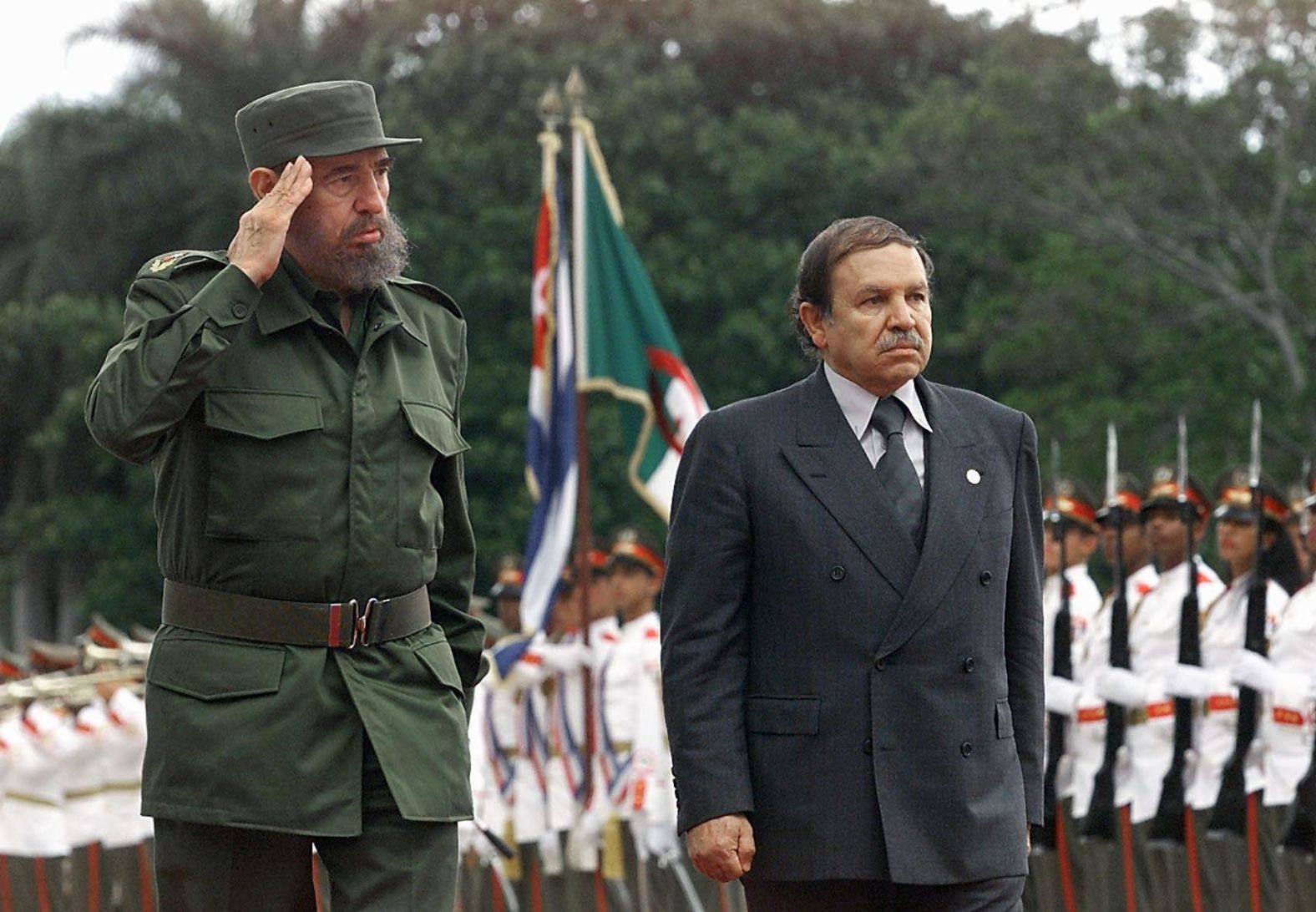 Cuban President Fidel Castro salutes troops alongside Bouteflika, who was making an official visit to Cuba in April 2000.
