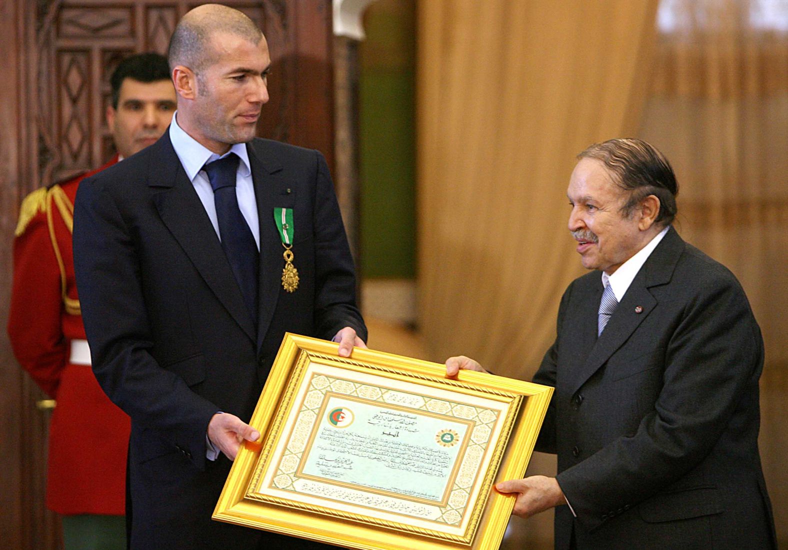 Bouteflika presents French soccer star Zinedine Zidane with Algeria's highest distinction, the Al-Athir medal, during a ceremony in December 2006. Zidane's parents emigrated to France from Algeria.