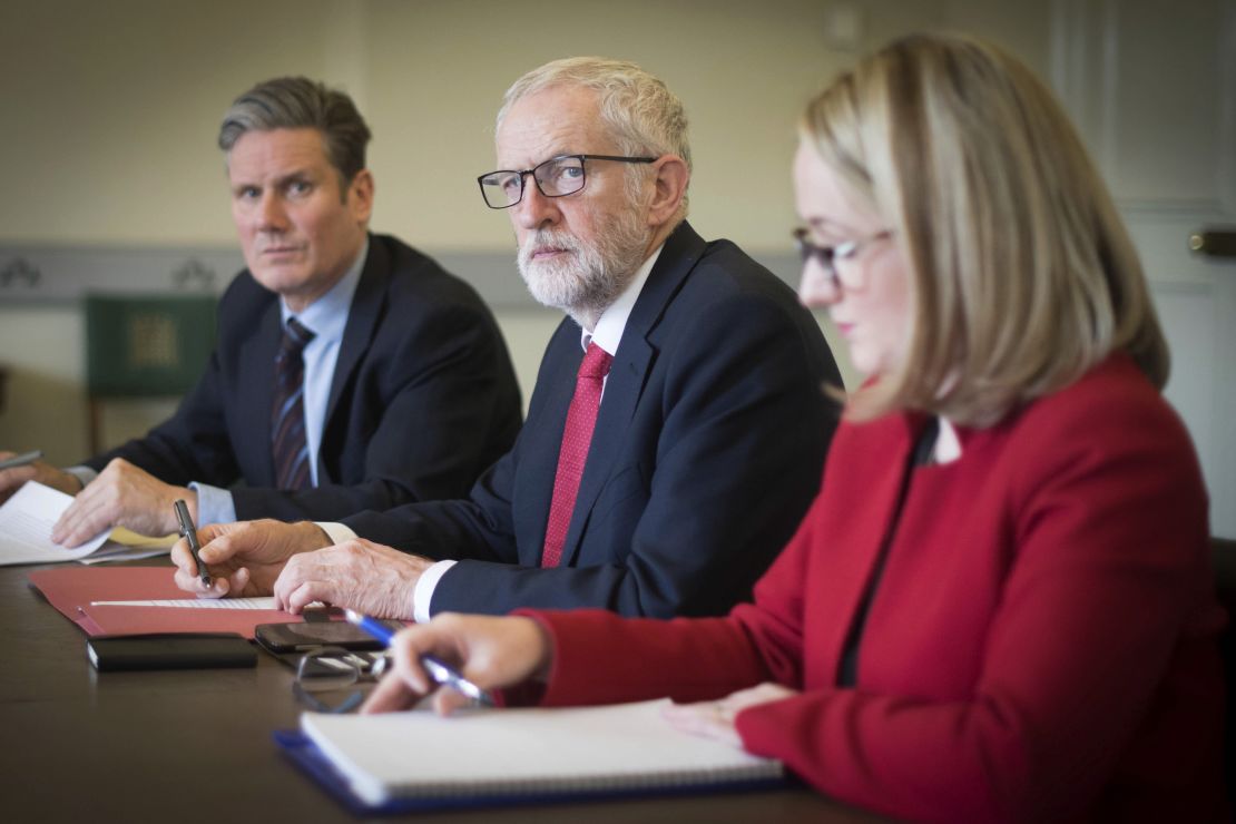 Labour leader Jeremy Corbyn (center) and key aides gather before a meeting with Theresa May
