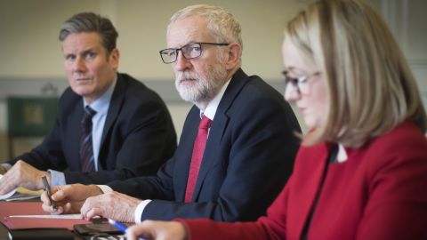 Labour leader Jeremy Corbyn (center) and key aides gather before a meeting with Theresa May
