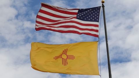 The US and New Mexico flags fly before the upcoming mid-term elections in Albuquerque, New Mexico on October 1, 2018. (Photo by Mark RALSTON /AFP/Getty Images)