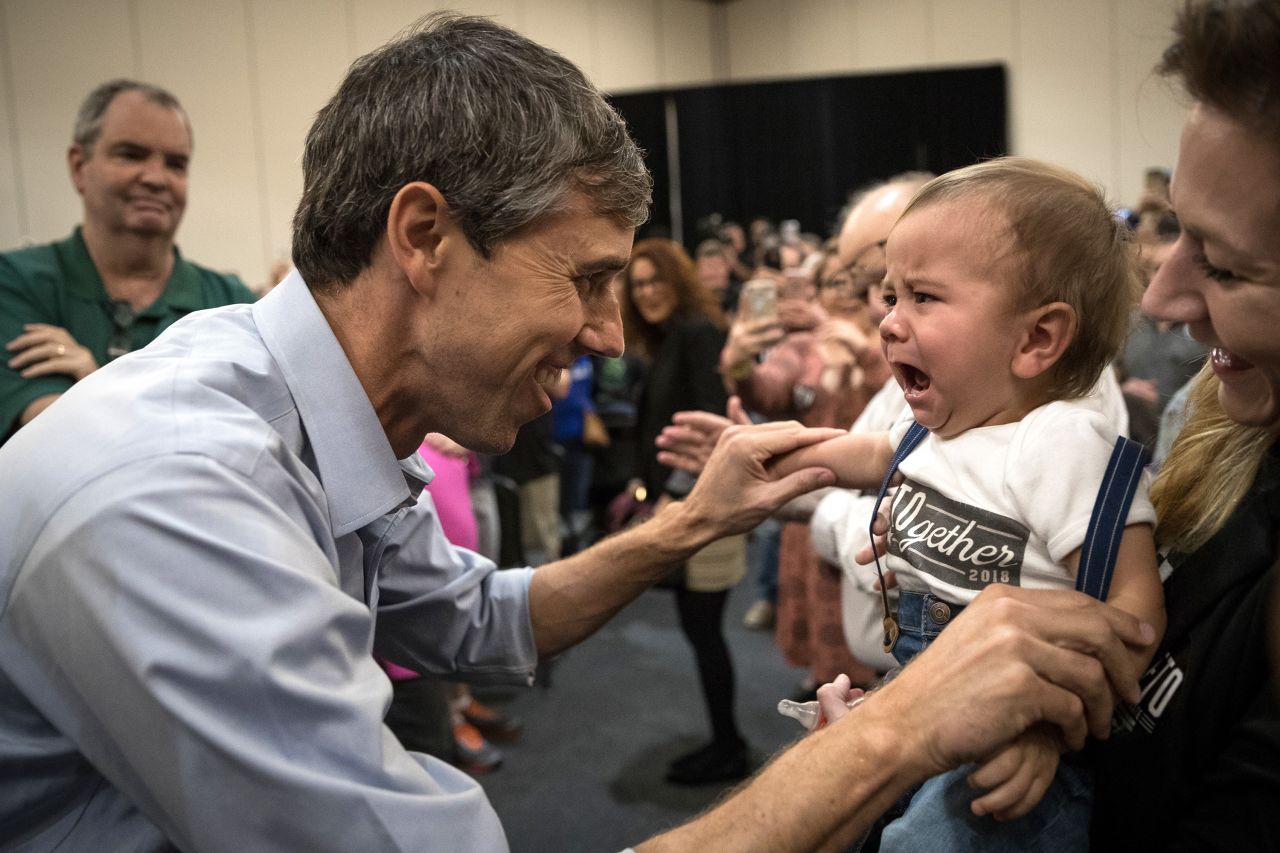 O'Rourke tries to cheer up a crying baby at a campaign rally in Conroe, Texas, in October 2018.