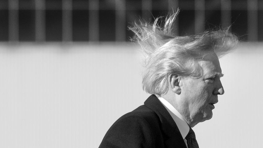 US President Donald Trump's hair blows in the wind as he boards Air Force One before flying to Vietnam to attend the annual Asia Pacific Economic Cooperation (APEC) summit at Beijing airport on November 10, 2017. / AFP PHOTO / JIM WATSON        (Photo credit should read JIM WATSON/AFP/Getty Images)