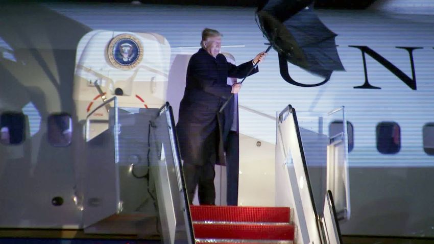 Trump's umbrella flips in wind off Air Force One