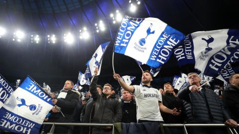 Spurs fans wave flags before the first Premier League game at the  new stadium.
